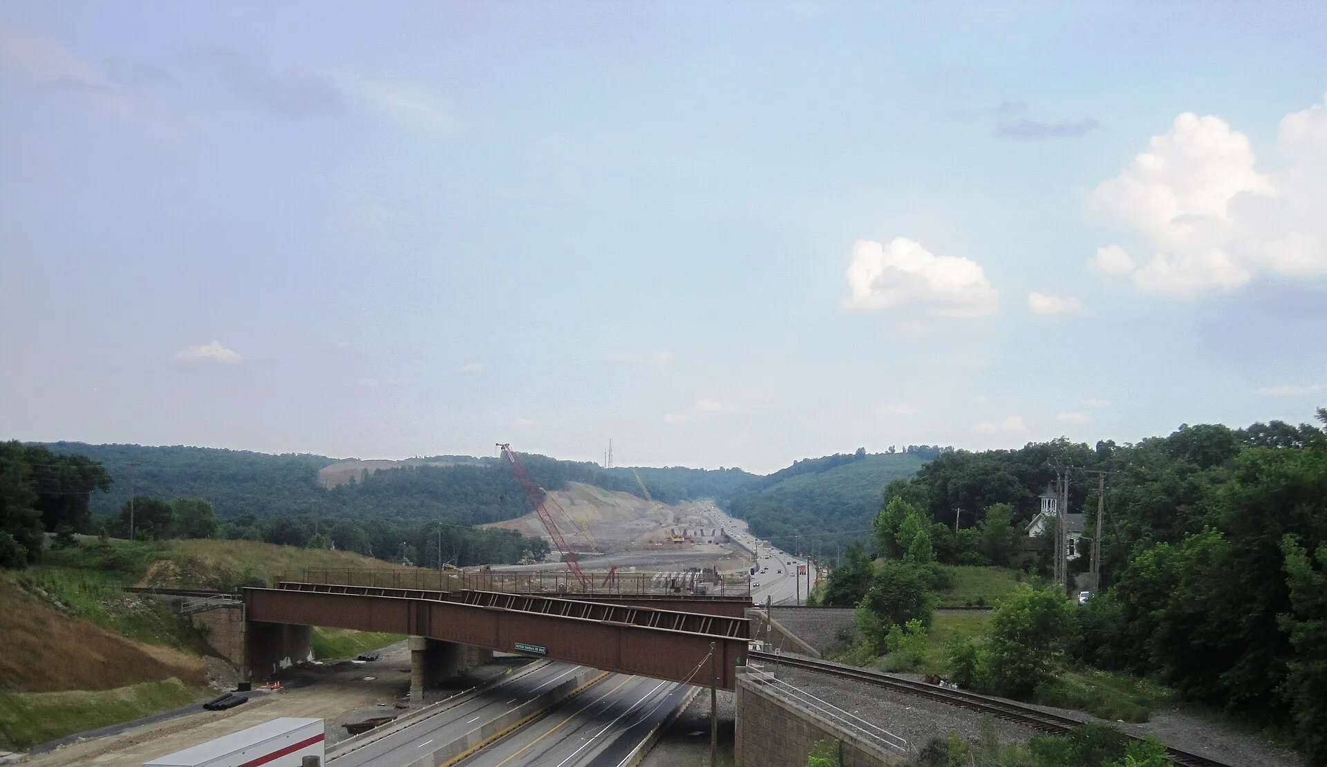Photo of ongoing construction of the new Beaver River Bridge carrying Interstate 76 / Pennsylvania Turnpike over the Beaver River between Big Beaver and North Sewickley Township , Pennsylvania . Photo taken from the State Street overpass over the Turnpike on the border of Big Beaver and Homewood looking east-southeast.
