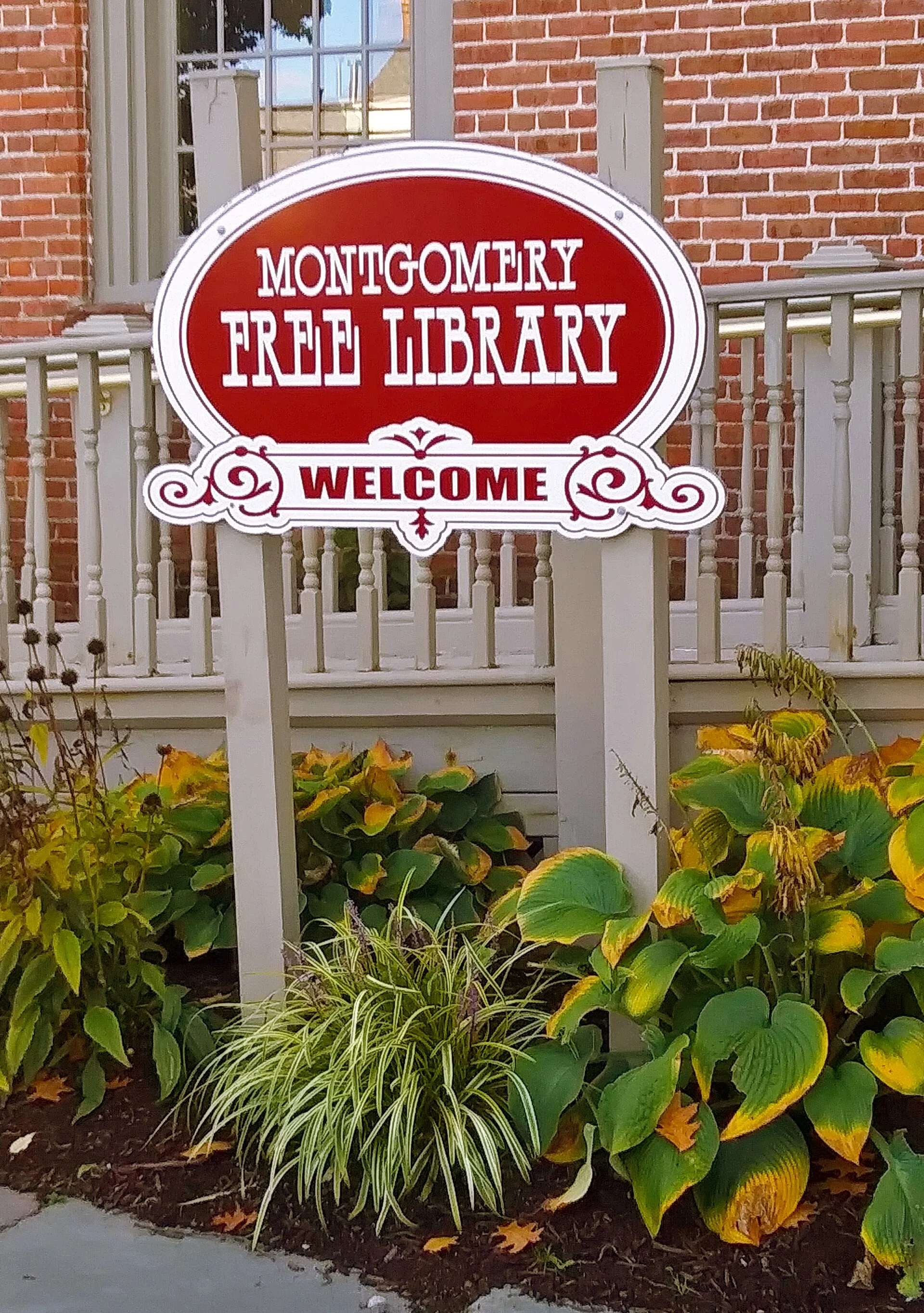 Sign for Montgomery, NY , public library, in front of the village hall building that houses it in one of its rooms