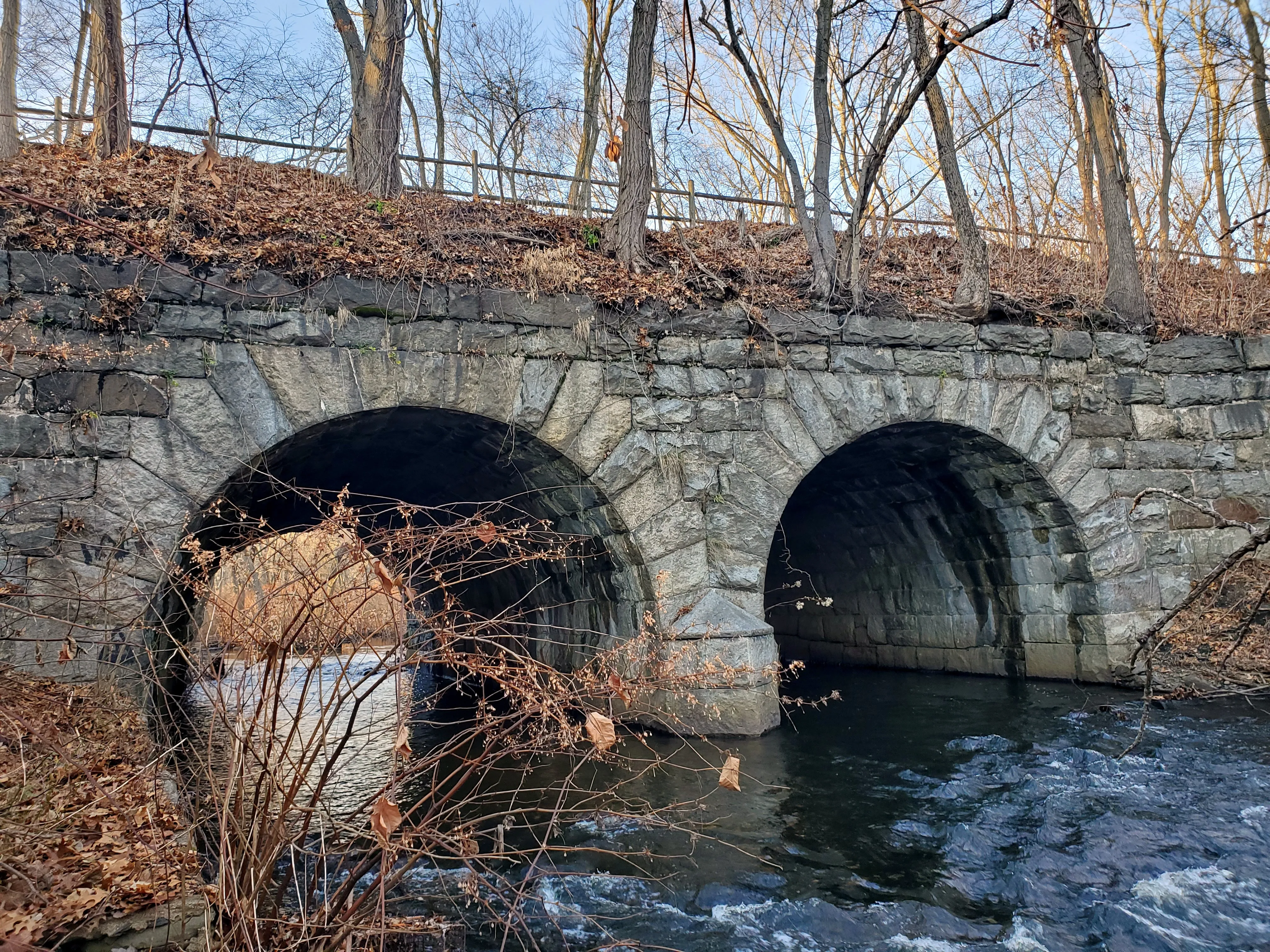 Double-arch bridge carrying the Washington Secondary Rail Trail over the Pocasset River, Cranston, December 2023.