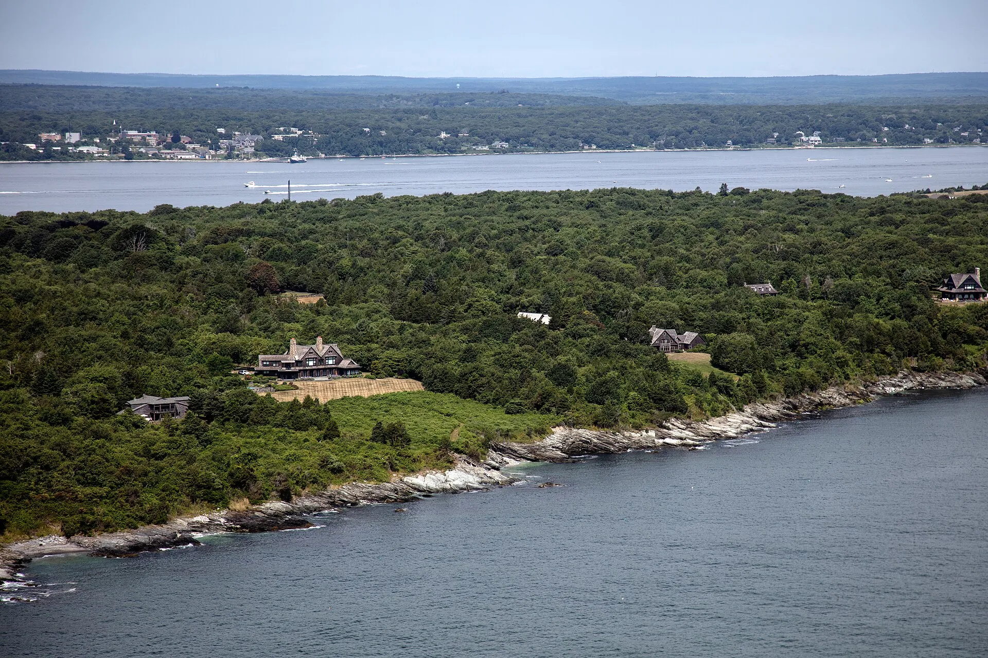 West–facing aerial view of Conanicut Island on Narragansett Bay in the U.S. state of Rhode Island. The house visible in the foreground is located at 333 Beavertail Rd….