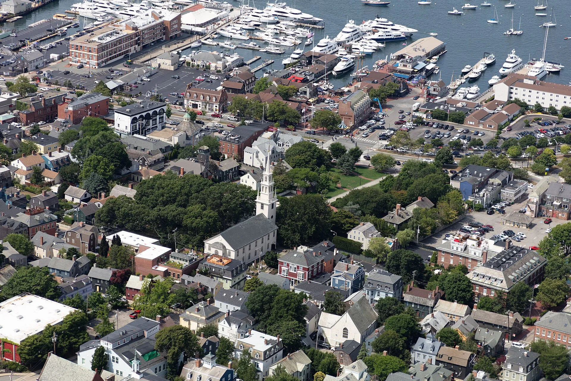 Aerial view of Newport on Aquidneck Island in the U.S. state of Rhode Island, with a focus on downtown and the harbor. The city is famous for its rich nautical….
