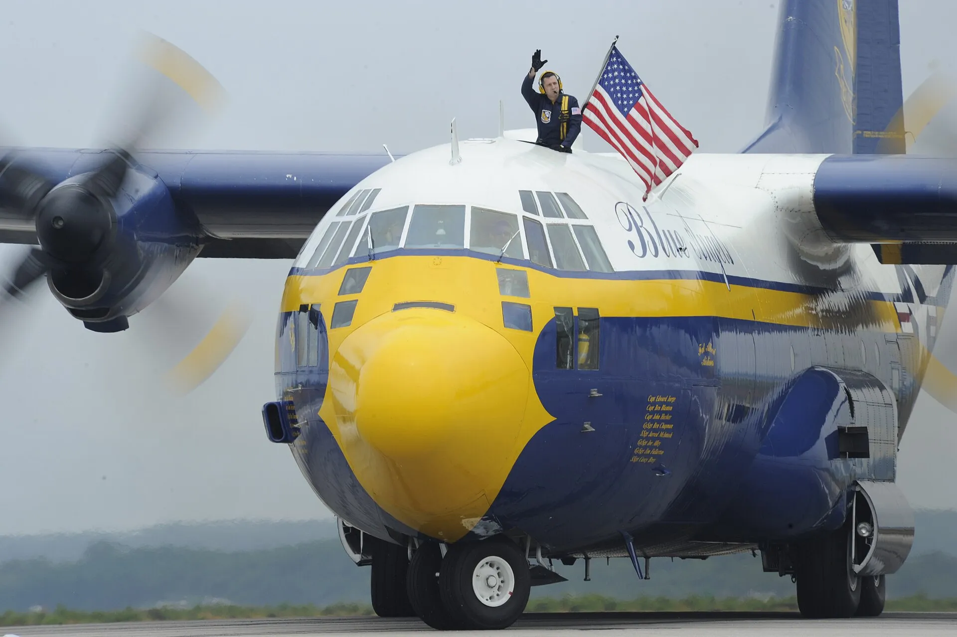 NORTH KINGSTOWN, R.I. (June 24, 2011) Marine Gunnery Sgt. Joe Alley, a C-130 navigator assigned to the U.S. Navy flight demonstration squadron, the Blue Angels, waves….