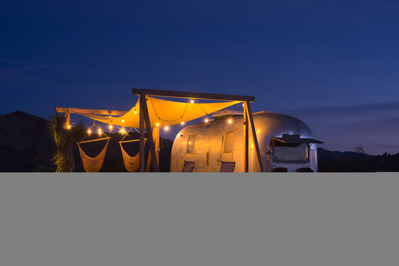 A 1963 Airstream Safari trailer in Joshua Tree at dusk