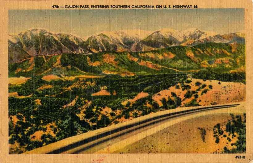 Vintage postcard view of Route 66 winding through Cajon Pass near Oak Hills