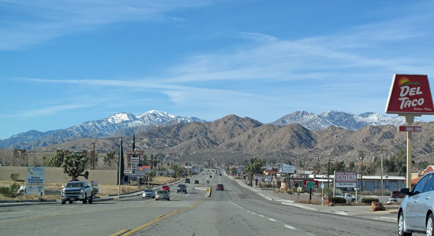 View west in Yucca Valley along State Route 62, San Bernardino Mountains in the distance