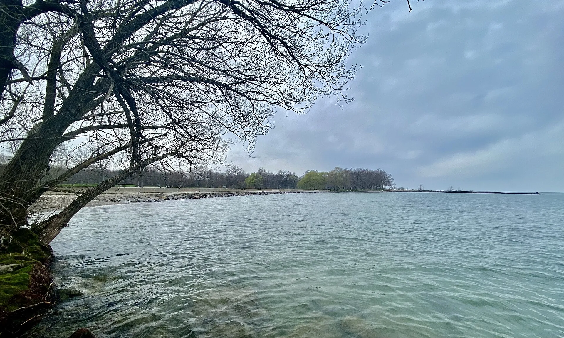 Looking westward along the Lake Ontario shore from a rocky pier at Hamlin Beach State Park