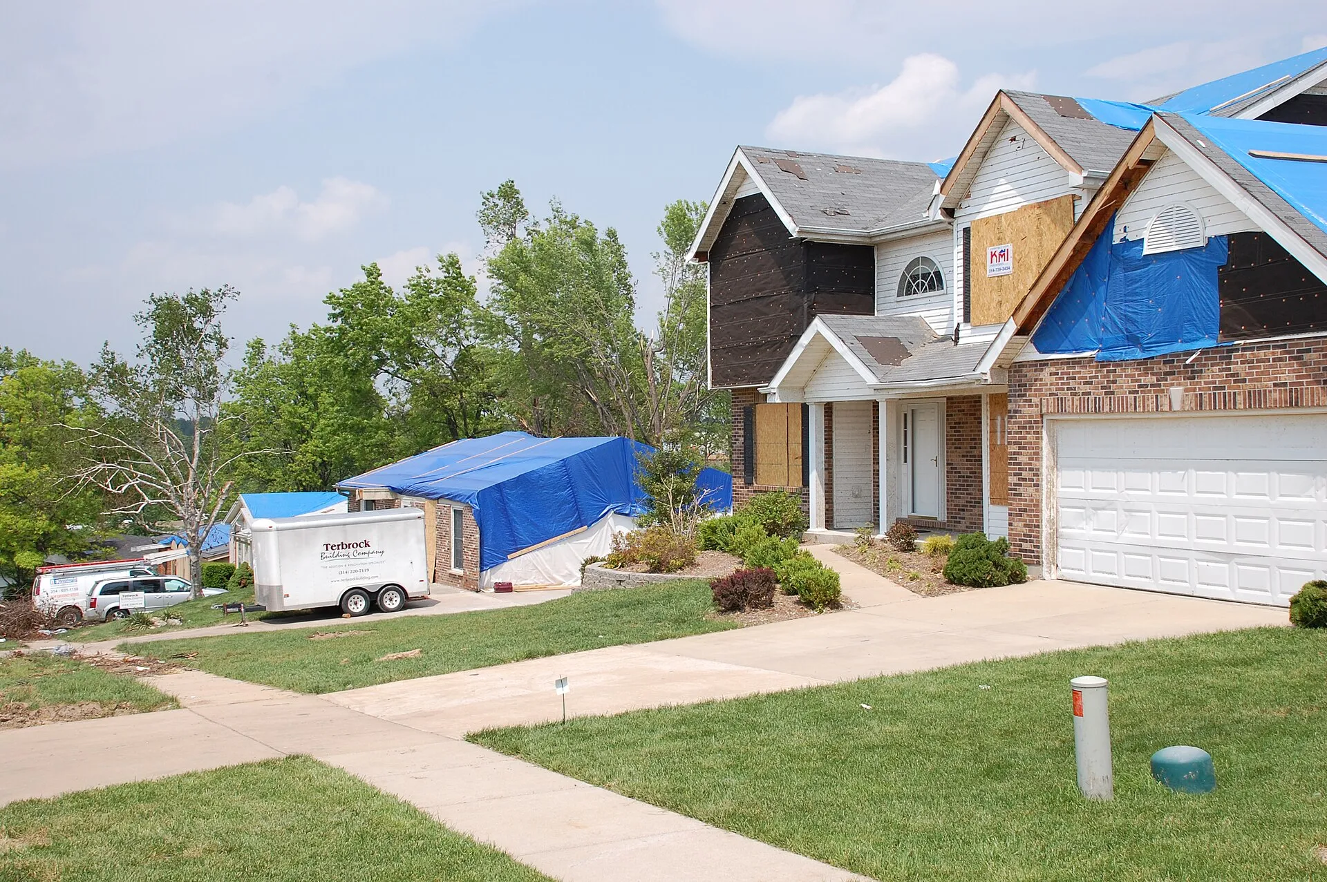 The original database describes this as: Title: Blue Roofs Show Recovery Production Date: 05/11/2011 Caption: Berkeley, Mo. , May 11, 2011 -- Blue roofs and clean driveways show the recovery is progressing for some in...