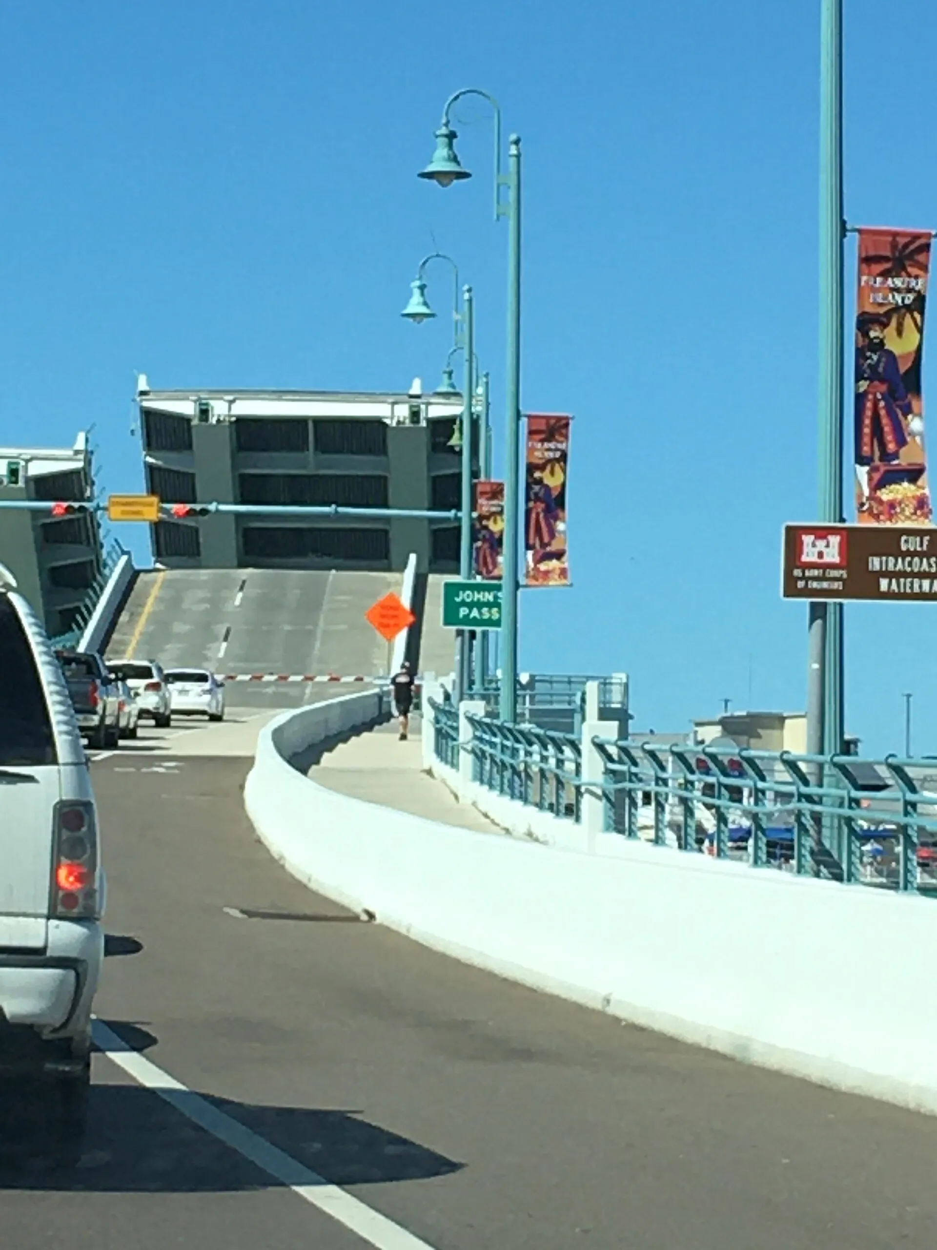 Cars wait as the John's Pass bridge opens over the Gulf Intracoastal Waterway at Madeira Beach, Florida.