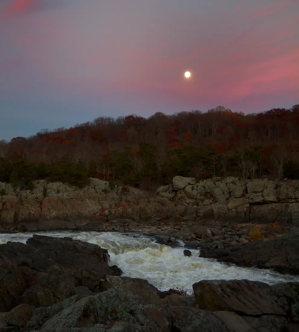 View of an early evening full moon rising over the Great Falls on the Potomac River Great Falls, Virginia