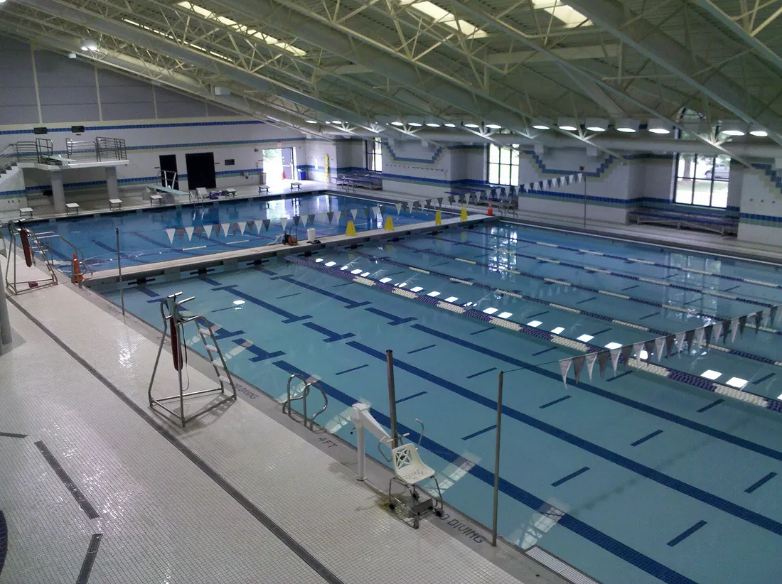 Main pool at Olney Indoor Swim Center in Olney, Maryland, looking towards the diving well.