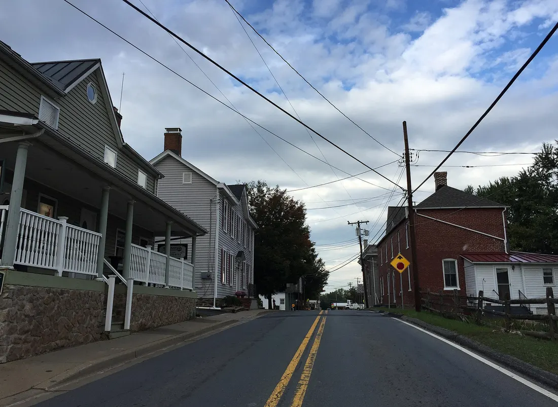 View west along Maryland State Route 107 (Fisher Avenue) at Norris Road in Poolesville, Montgomery County, Maryland