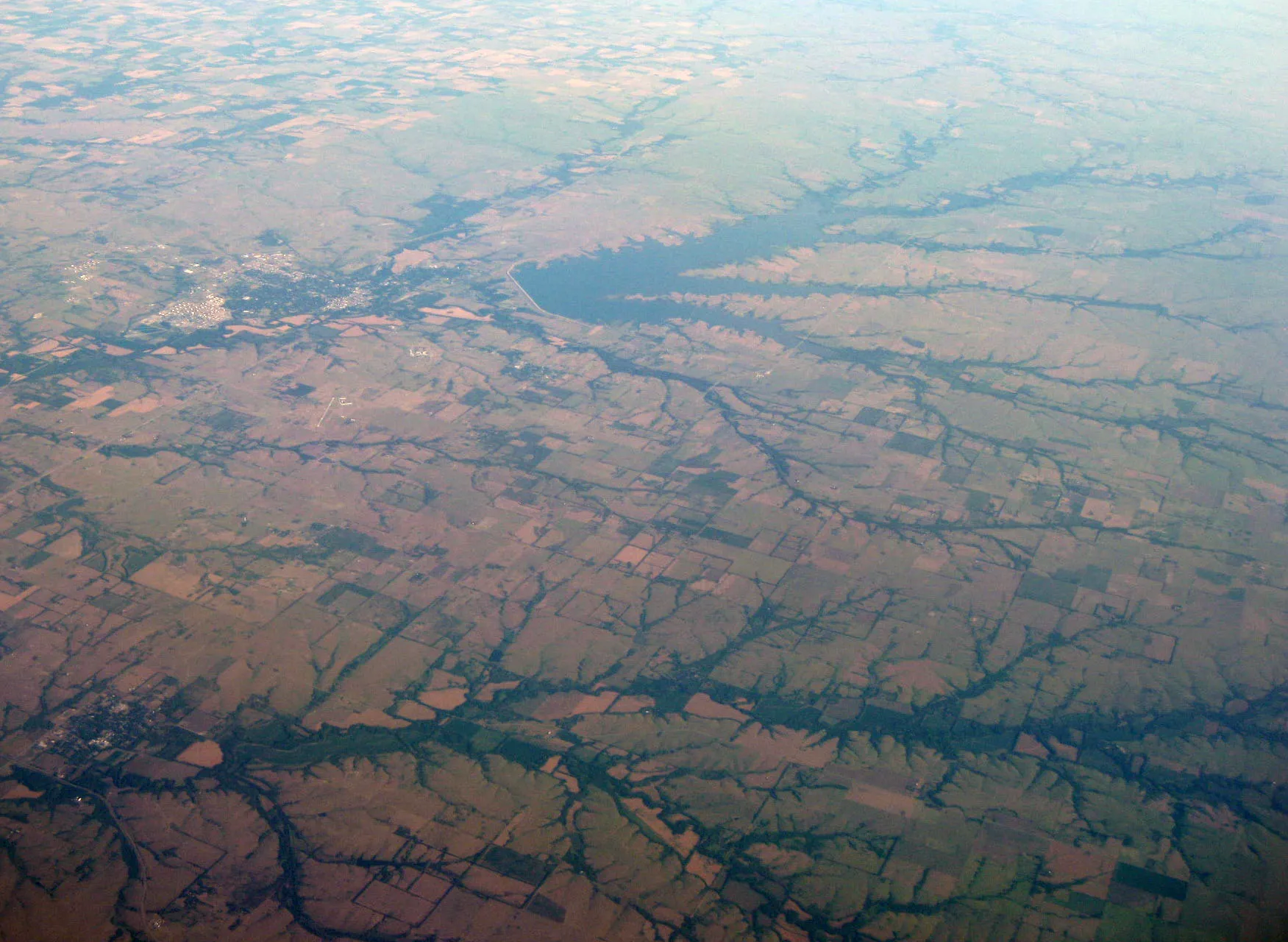 Oblique air photo of El Dorado, Kansas and El Dorado Lake , facing northwest. 1 August 2011. Color and contrast enhanced in Photoshop.